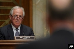 FILE - Chairman Sen. Bob Corker, R-Tenn., left, listens during a Senate Foreign Relations Committee hearing on Capitol Hill in Washington.