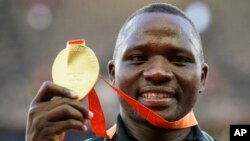 FILE - Javelin gold medalist Kenya's Julius Yego celebrates on the podium at the World Athletics Championships at the Bird's Nest stadium in Beijing, Aug. 27, 2015