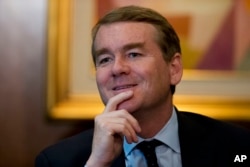 FILE - U.S. Senator Michael Bennet, D-Colo., speaks with reporters in Mexico City, July 4, 2017. Bennet said Jan. 14, 2018, that U.S. lawmakers "should stop shutting this government down, and we should start doing the work the American people sent us to Washington to do."