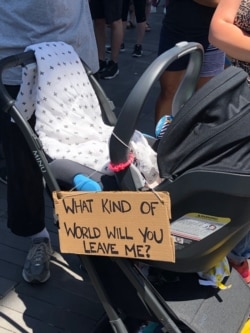 Signs show support for racial equity at a rally in Brooklyn, New York, June 9, 2020. (Margaret Besheer/VOA)
