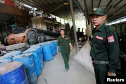 FILE - United Wa State Army (UWSA) soldiers are seen in a tin mine factory at Man Maw in ethnic Wa territory in northeast Myanmar, Oct. 5, 2016.