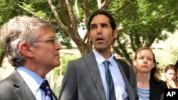 Scott Warren speaks outside federal court, June 11, 2019, in Tucson, Arizona, after a mistrial was declared. The jury said it was deadlocked in the case against Warren, a border activist charged with conspiracy to transport and harbor migrants.