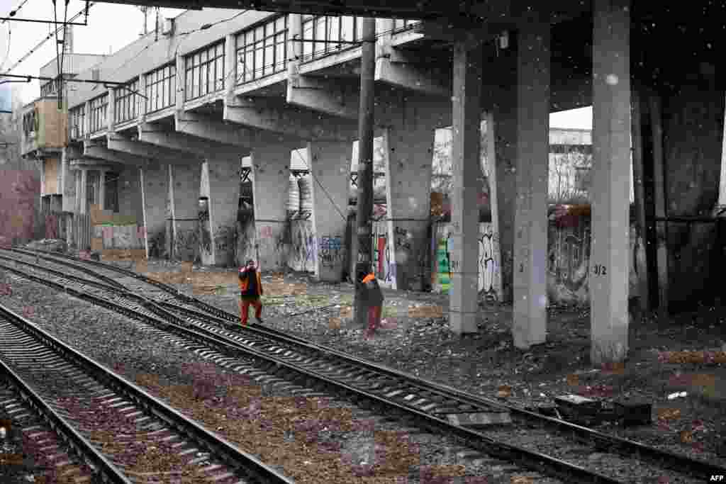 Workers examine the damage at the Kyiv central railway station which is said was hit by a night explosion in Kyiv, Ukraine, March 3, 2022. 