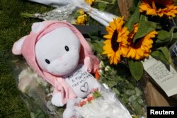 A child's stuffed toy with the message, "Thoughts to All the Victims" is seen as people pay tribute near the scene where a truck ran into a crowd at high speed killing scores and injuring more who were celebrating the Bastille Day national holiday, in Nic