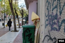 A foam mattress propped against the wall near Victoria Square. Some refugees and migrants continue to sleep rough, or in squats, around Athens. (Photo: J. Owens for VOA)
