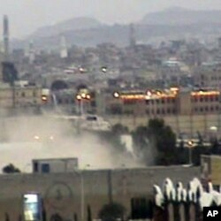 In this image taken from TV, showing Yemeni army helicopter emerging from the dust as it airlifts U.S. and other ambassadors out of a besieged embassy in Sanaa, Yemen, to the Presidential Palace to witness ruling party leaders signing an agreement for the