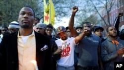 Protesters stand outside the Baltimore Police Department's Western District police station at the end of a march for Freddie Gray, in Baltimore, Maryland, April 21, 2015.