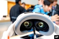 An Apple Vision Pro headset rests on display during the first day of sales at a Palo Alto, Calif., Apple store on Friday, Feb. 2, 2024. (AP Photo/Noah Berger)