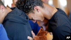 Austin Burden, 17, cries on the shoulder of a friend after a vigil at the Parkland Baptist Church, for the victims of the Wednesday shooting at Marjory Stoneman Douglas High School, in Parkland, Fla., Feb. 15, 2018. 