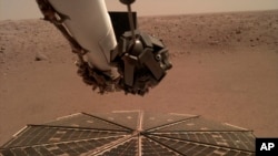 This Friday, Dec. 7, 2018 photo made available by NASA shows a view from the arm-mounted camera on the InSight Mars lander. The spacecraft arrived on the planet on Nov. 26. 