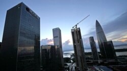 FILE: The Evergrande Group headquarters at left is seen near other skyscrapers and construction sites in Shenzhen in southern China's Guangdong province, Sept. 24, 2021.