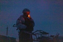 A Ukrainian soldier smokes at the line of separation from pro-Russian rebels, Donetsk region, Ukraine, Dec 30, 2021. Presidents Joe Biden and Vladimir Putin spoke by phone on Thursday about the Russian troop buildup near Ukraine.