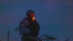 A Ukrainian soldier smokes at the line of separation from pro-Russian rebels, Donetsk region, Ukraine, Dec 30, 2021. Presidents Joe Biden and Vladimir Putin spoke by phone on Thursday about the Russian troop buildup near Ukraine.