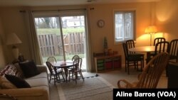 The family room is fully furnished, including a rocking chair, in a three-story townhouse in Columbia, Maryland. The house is ready for the arrival of a refugee family from Afghanistan. (A. Barros/VOA)