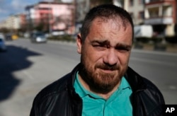 In this March 20, 2017, photo, Syrian Tarek Muharram, 39, who quit his banking job to return home and join the Syrian rebellion in 2012, poses for a photo in Gaziantep, southeastern Turkey, where he now lives.
