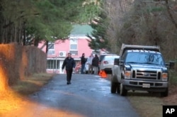 FILE - An entrance to the grounds of a riverfront compound near Centreville, Maryland, that has been used by Russian Federation diplomats for years is blocked to reporters by State Department personnel, Dec. 29, 2016.