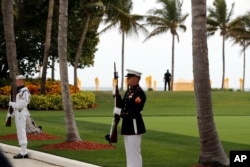 FILE - Military personnel stand for the arrival of Chinese President Xi Jinping and his wife, Chinese first lady Peng Liyuan, as they arrive at Mar-a-Lago to meet with President Donald Trump and first lady Melania Trump, in Palm Beach, Florida, April 6, 2017.