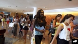Miss World pageant contestants leave Bali International Convention Center after a rehearsal in Nusa Dua, Bali, Indonesia, Sept. 16, 2013.