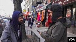 Yemeni-American Ali Abdul (left) and Mohammed Ghaleb, a permanent resident from Yemen, chat following afternoon prayer at Masjid al-Farooq, in Brooklyn, NY. (R. Taylor/VOA)