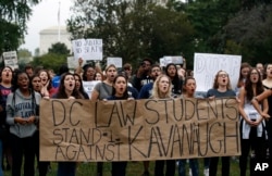 Activists demonstrate on the lawn of the East Front of the U.S. Capitol to protest the confirmation vote of Supreme Court nominee Brett Kavanaugh on Capitol Hill, Oct. 6, 2018, in Washington.