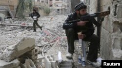 A Free Syrian Army fighter is seen taking a breakfast break during heavy fighting in Mleha suburb of Damascus January 25, 2013.