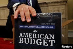 Copies of the President Trump's FY 2019 budget proposal are delivered to the U.S. House Budget Committee offices on Capitol Hill in Washington, Feb. 12, 2018.