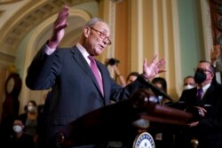 FILE - Senate Majority Leader Chuck Schumer, D-N.Y., speaks to reporters at the Capitol in Washington, Sept. 28, 2021.