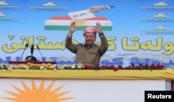 FILE - Iraqi Kurdish President Masoud Barzani gestures as he attends a rally in support for the Sept. 25 independence referendum in Zakho, Iraq, Sept. 14, 2017.
