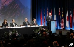 New Zealand Prime Minister John Key, right, speaks to delegates at the signing of the Trans-Pacific Partnership agreement in Auckland, New Zealand, Feb. 4, 2016.