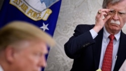 In this file photo taken on May 13, 2019, National Security Advisor John Bolton listens while US President Donald Trump speaks to the press before a meeting with Hungary's Prime Minister Viktor Orban in the Oval Office of the White House in Washington, DC