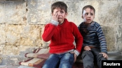 Injured boys react at a field hospital after airstrikes on the rebel-held areas of Aleppo, Syria, Nov. 18, 2016. A Syrian opposition group has called on the United Nations to &quot;take immediate, definitive steps to protect civilians in Aleppo and stop the barbaric offensive against them.&quot;