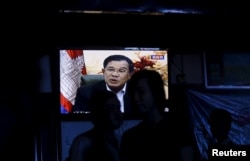 FILE - Cambodia's Prime Minister Hun Sen is seen on a television as he delivers a speech, at a restaurant in central Phnom Penh, Oct. 28, 2015.