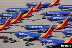 FILE - A number of grounded Southwest Airlines Boeing 737 MAX 8 aircraft are shown parked at Victorville Airport in Victorville, California, March 26, 2019.