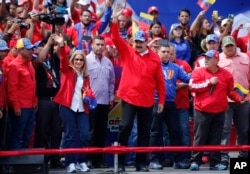 President Nicolas Maduro and first lady Cilia Flores greet supporters as they arrive at a rally in Caracas, Venezuela, Feb. 2, 2019.