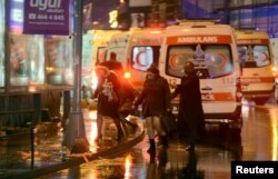 People run away from a nightclub where a gun attack took place during a New Year's Eve party in Istanbul, Turkey, Jan. 1, 2017.