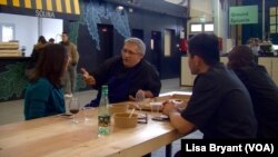 Nabil Attar chats with customers after cooking.