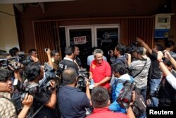 Police and security are seen outside the club where police detained 141 gay men in Jakarta, Indonesia May 23, 2017.