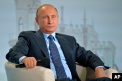 FILE - Russian President Vladimir Putin attends a meeting of the Russian People's Front movement in the Black Sea resort of Yalta, Crimea, Oct. 26, 2016.