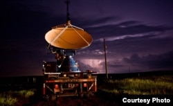 A Nebraska field with lightning in the background. (Photo by Gino DeGrandis)