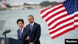Japanese Prime Minister Shinzo Abe, left, and U.S. President Barack Obama speak at Joint Base Pearl Harbor-Hickam, Hawaii, Dec. 27, 2016.