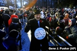 Groundhog Club inner circle member John Grusky wears a thermometer around his neck as he makes the trek to Gobblers Knob for the celebration of the 132nd Groundhog Day in Punxsutawney, Pa. Friday, Feb. 2, 2018.
