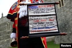 A man makes an announcement outside Windsor Castle that Britain's Meghan, the Duchess of Sussex gave birth to a boy, in Windsor, Britain, May 6, 2019.