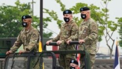 FILE - Incoming commander, Gen. Paul J. LaCamera, right, and outgoing commander, Gen. Robert B. Abrams, center, during a change-of-command ceremony at Barker Field in Pyeongtaek, South Korea, July 2, 2021.