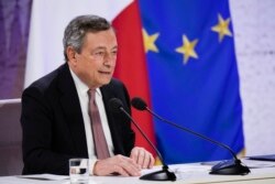 Italy's Prime Minister Mario Draghi reads statement during a press conference at the La Nuvola conference center for the G20 summit in Rome, Oct. 31, 2021.