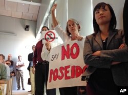 FILE - Scores of supporters and critics of a proposed $900 million desalination plant pack a meeting of the California Coastal Commission, in Huntington Beach, Calif., Nov. 13, 2013. Builder Poseidon Water hopes to begin construction in 2016.