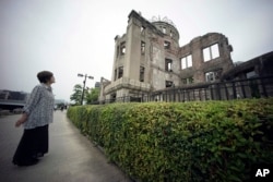 FILE - In this July 3, 2015, photo, Kimie Mihara, a survivor of the 1945 atomic bombing, looks at the Atomic Bomb Dome, as it is known today in Hiroshima, Hiroshima Prefecture, southern Japan.