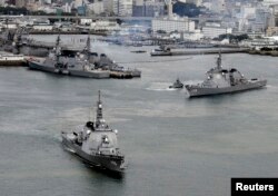 Japan Maritime Self-Defense Force's (JMSDF) Aegis destroyers Myoko (L) and Kongo sail off from the JMSDF Sasebo base in Sasebo, southern Japan, in this photo taken by Kyodo, Dec. 6, 2012.