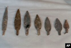 Pointed heads of Indigenous lances rescued from the ashes of the fire that swept through Rio’s National Museum in September, are displayed during a media presentation, in Rio de Janeiro, Brazil, Dec. 10, 2018.