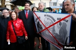 FILE - Rabbi Paul Chaim Eisenberg, left, and Oskar Deutsch, president of the Jewish Community of Vienna, third from left, participate in a protest against anti-Semitism in Vienna, Sept. 12, 2012.