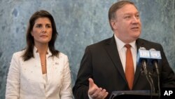 FILE - Former U.S. Secretary of State Mike Pompeo, right, with former U.S. Ambassador to the United Nations Nikki Haley, left, speaks at UN headquarters, July 20, 2018. Donald Trump said the two, who served in his first administration, will not serve in his second administration.